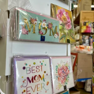 A display of Mother's Day cards in the foreground with a store interior in the background